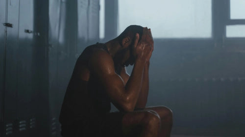 Man stretching after workout in the sunset